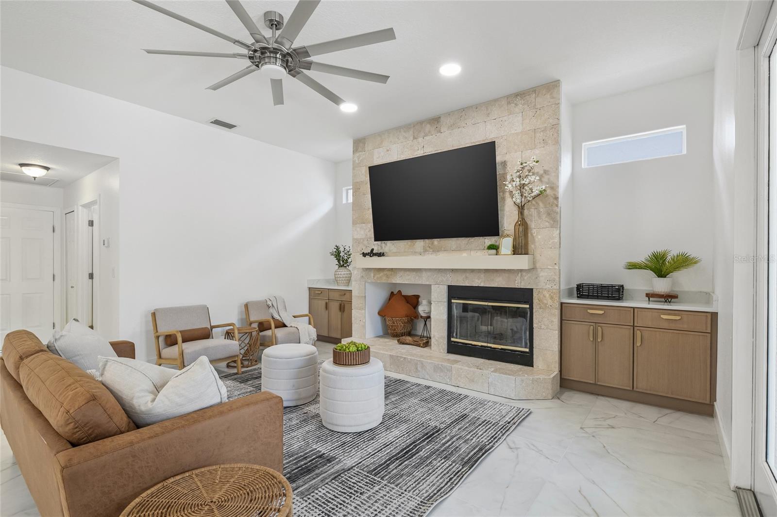 Bookended built in cabinets anchor the fireplace.