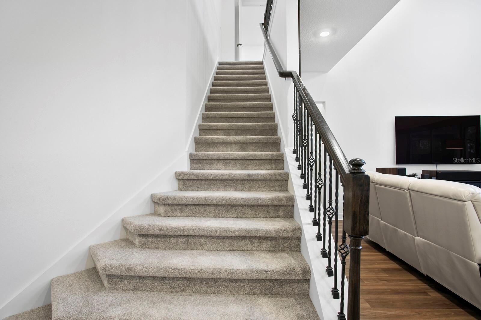 Wrought Iron balustrades adorn the staircase and upstairs oak railings