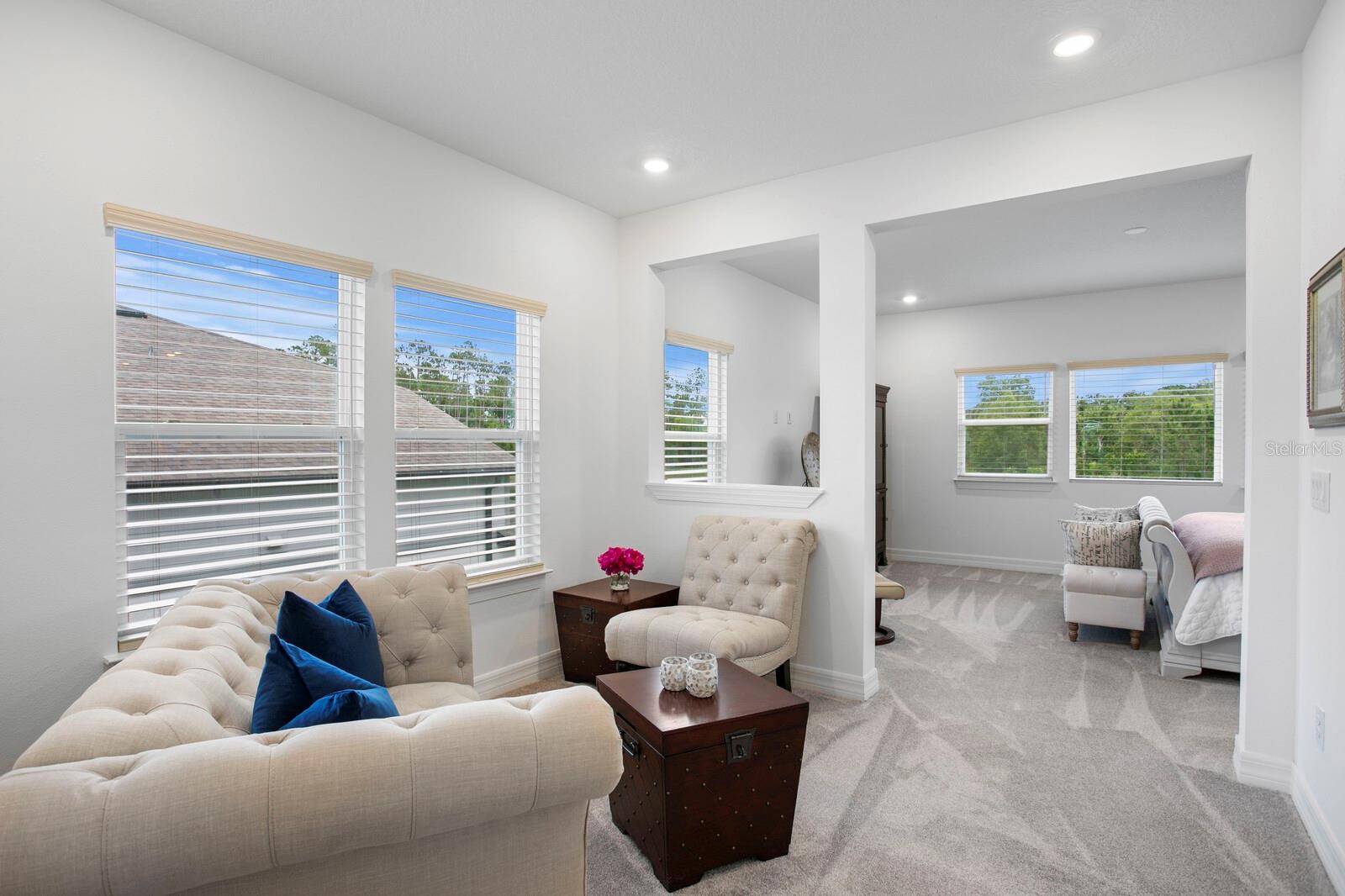 Sitting area between the primary suite and bath