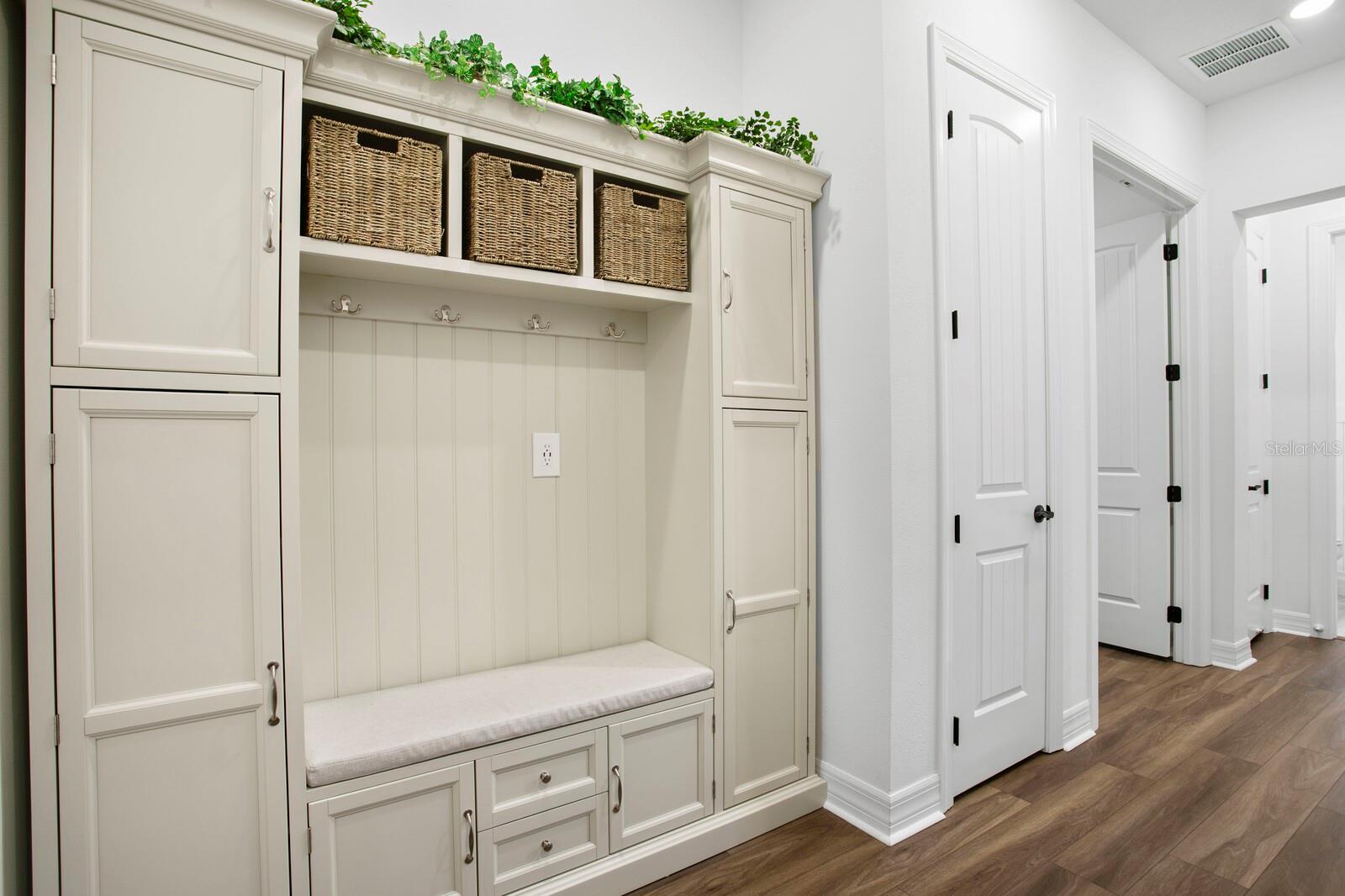 Hallway from garage with custom drop zone and storage