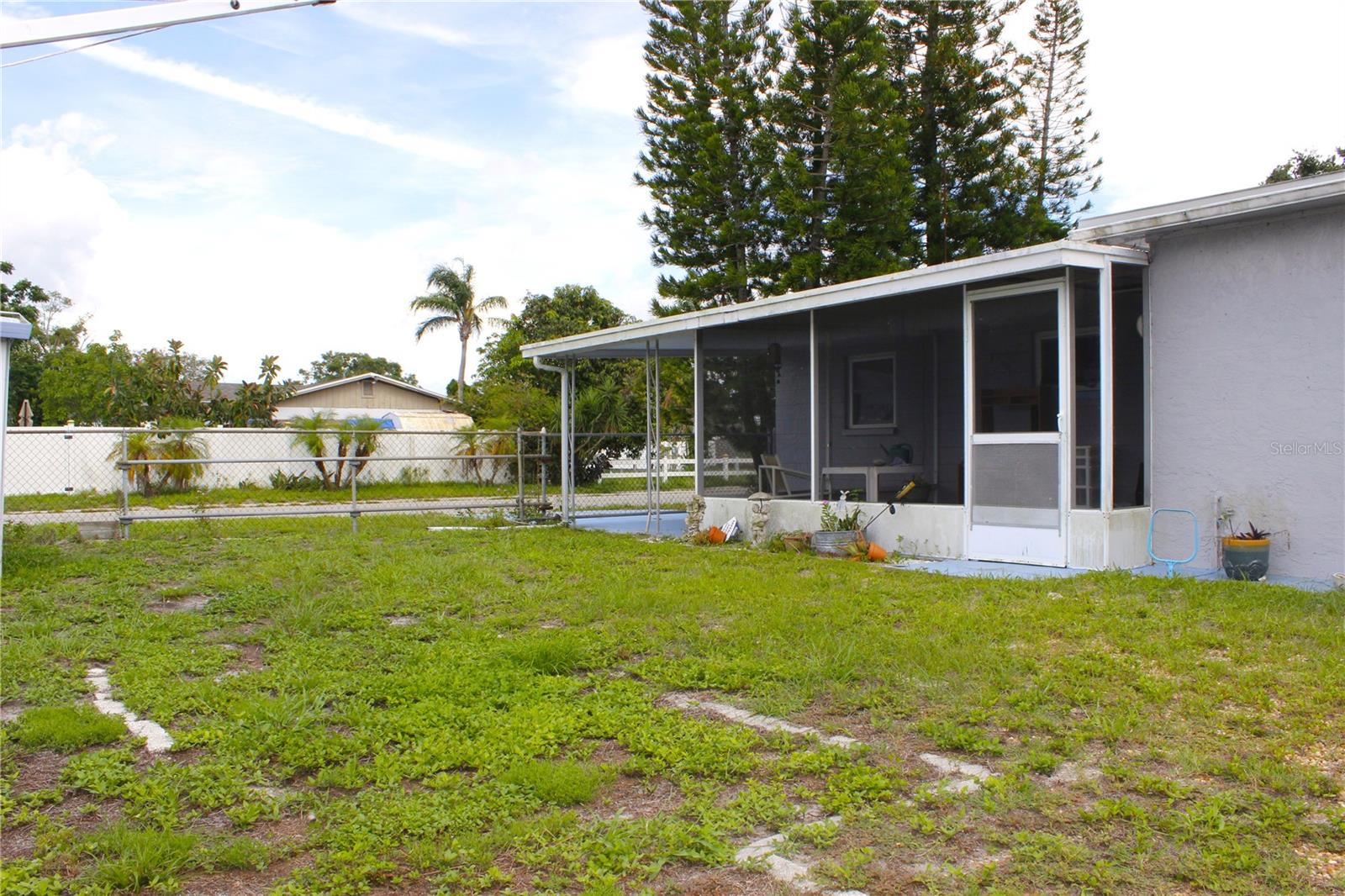 BACK YARD VIEW TO SCREENED LANAI