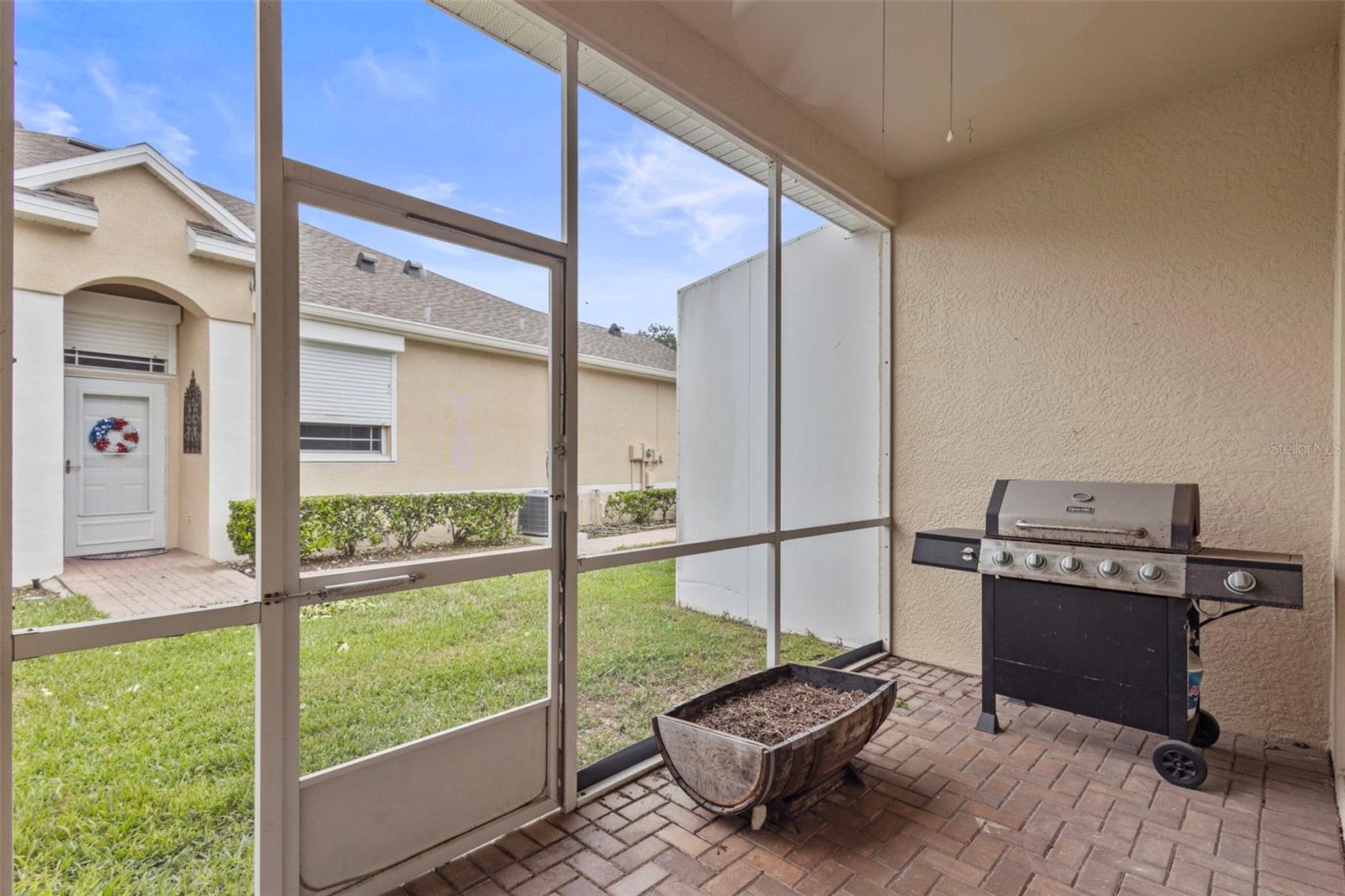 screened back patio is perfect for enjoying cool nights and grilling with friends