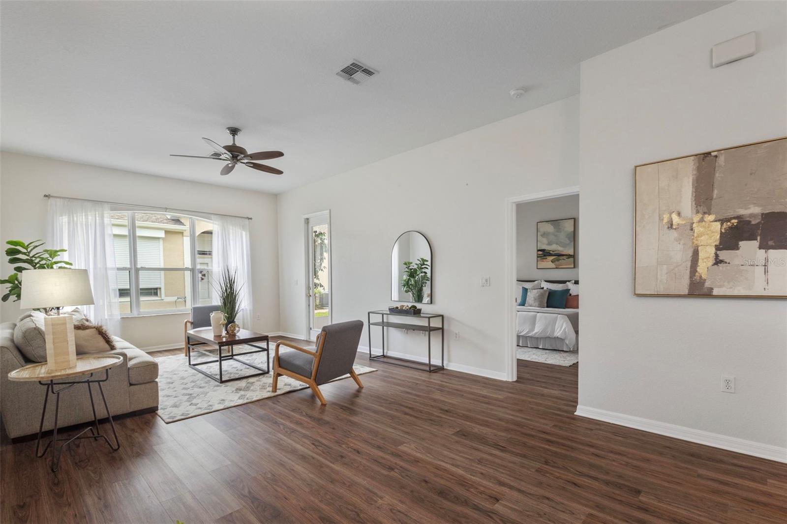 great room into primary suite and door to screened patio