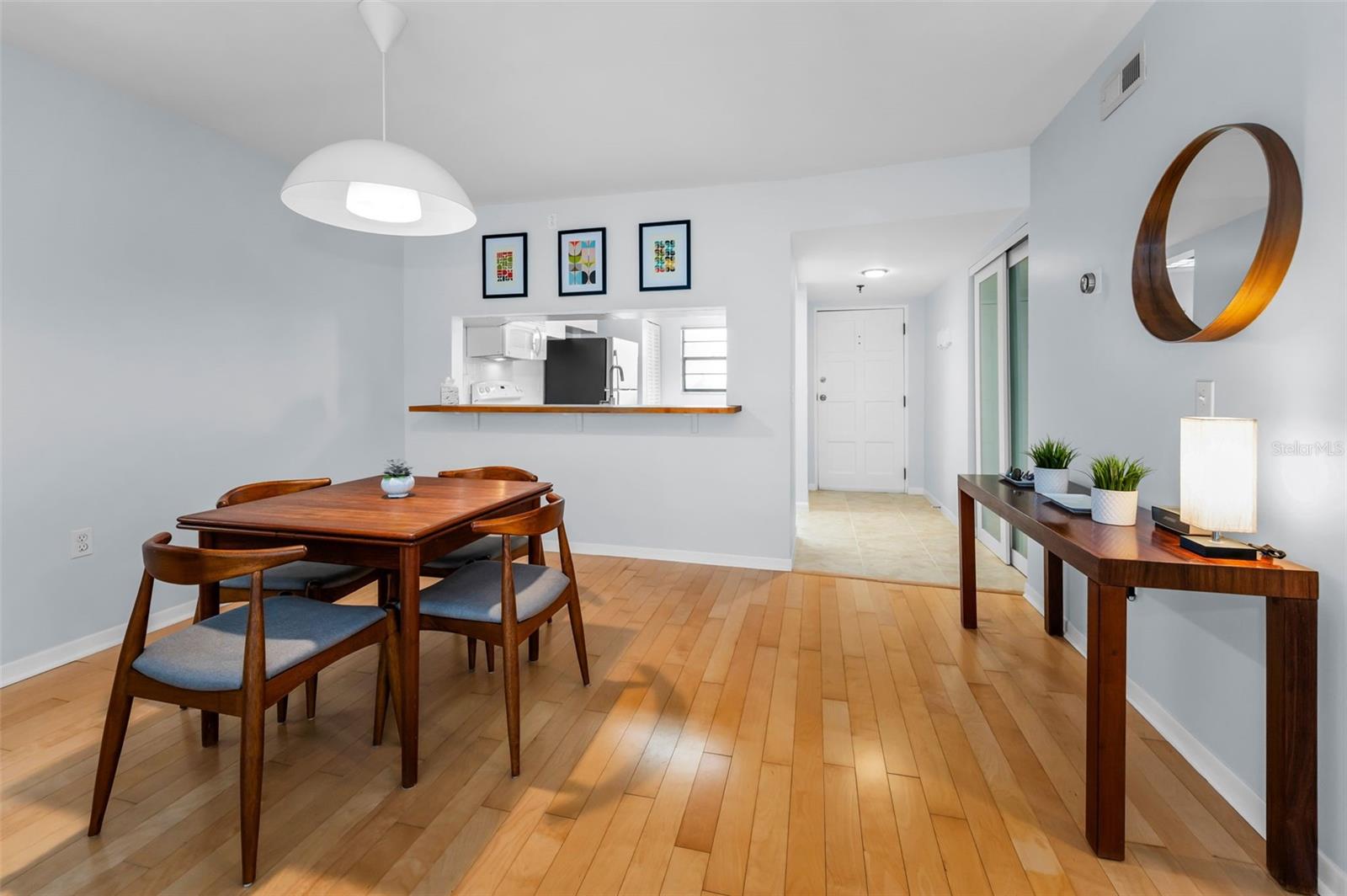 ...Kitchen Looking in. Plenty of Natural Light. Washer & Dryer Behind White Doors.