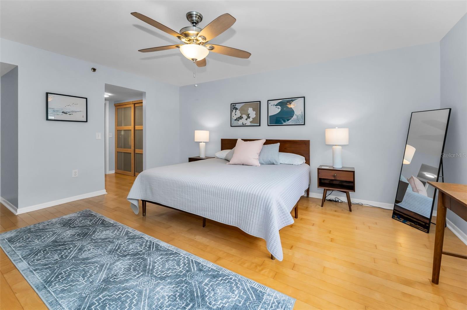 .. Master Bedroom Suite Has His & Hers Closets with Smoked Glass Sliders.