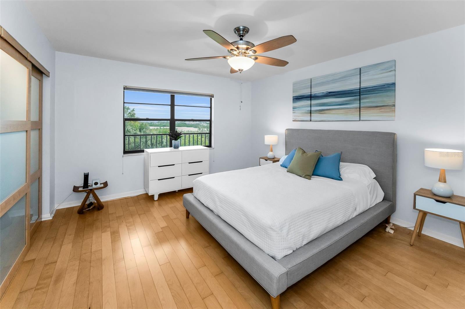 ..Guest Bedroom 12.11 x 13.5.. Smoked Glass Closet Sliders Provide a European Flair to Design.