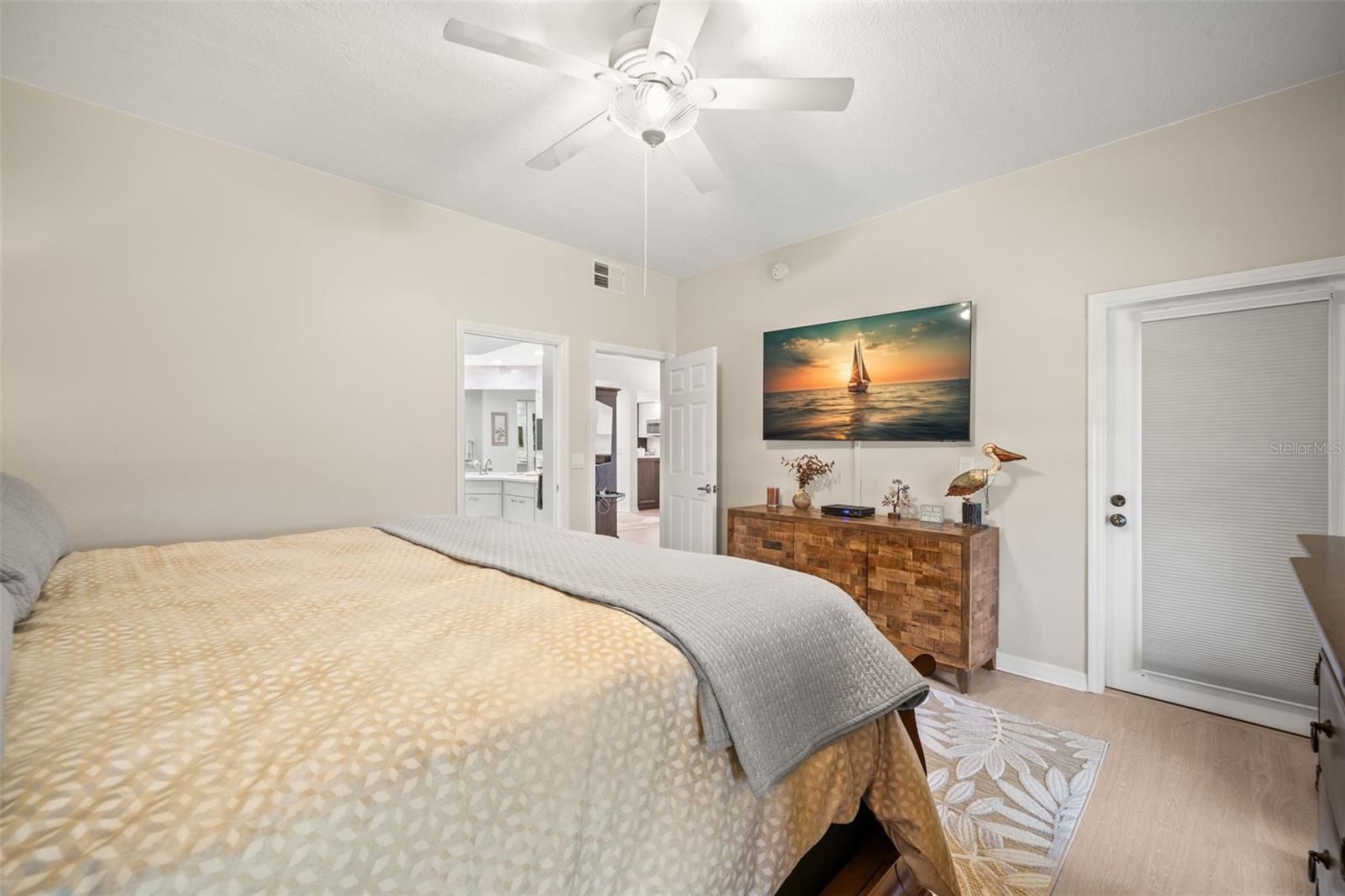 Primary Bedroom / Door leading out to the patio / Spacious walk-in closet.