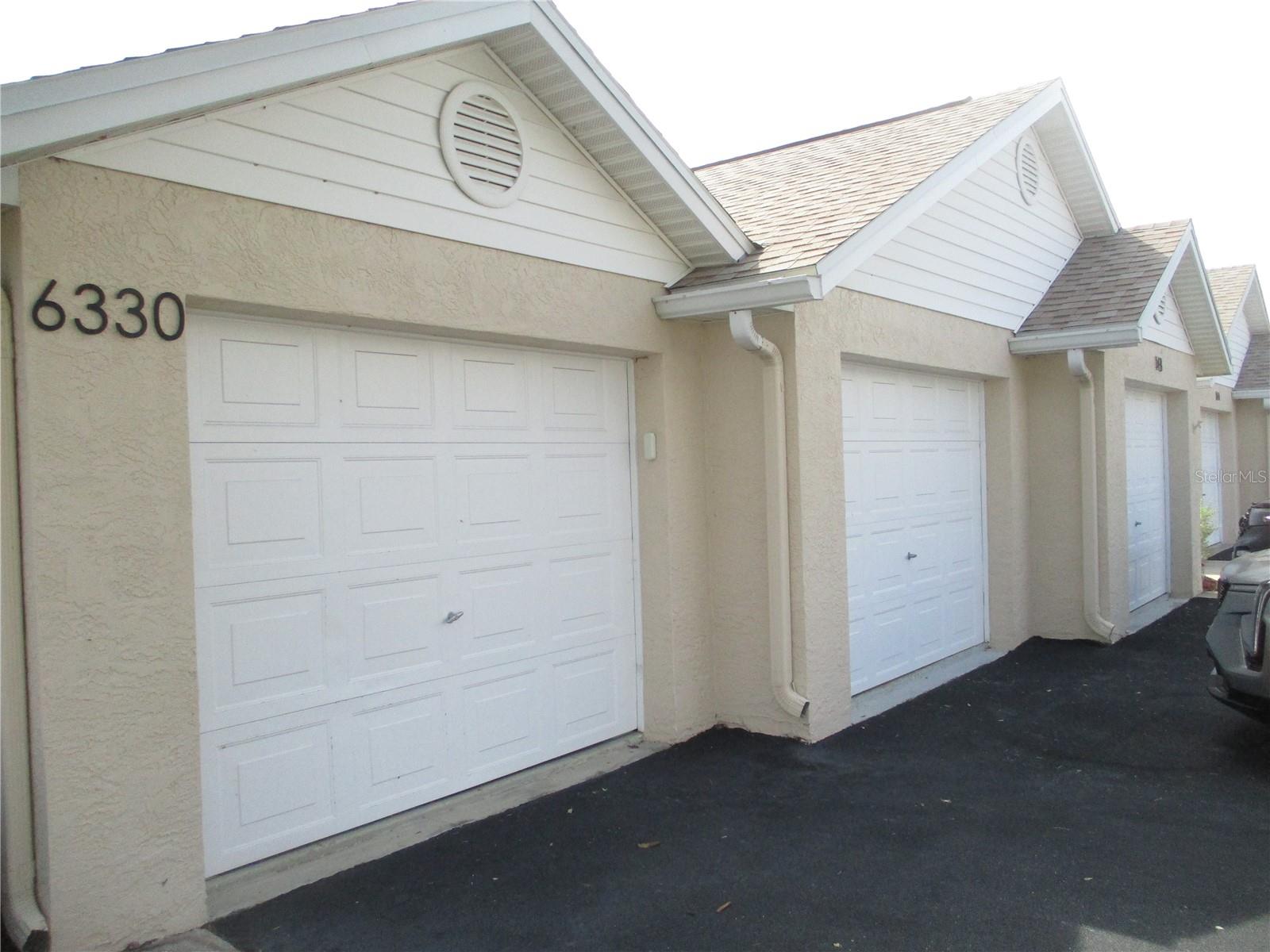 Three-car garage: a two-car garage and a one-car garage, connected by an internal door.  Garage also features attic space for storage.