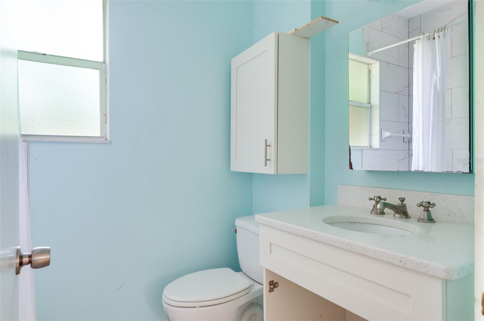Bathroom. Newer vanity, toilet, and bath.