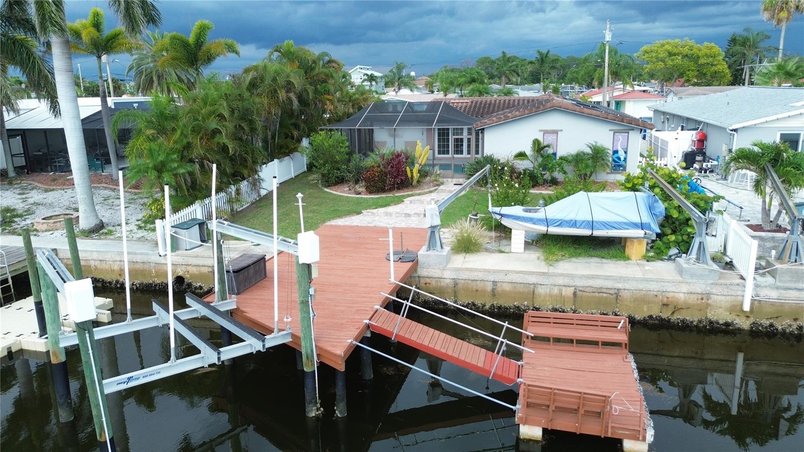 Canal front with deep water Gulf access, a 10,000 lb boat lift, a davit and a floating dock.