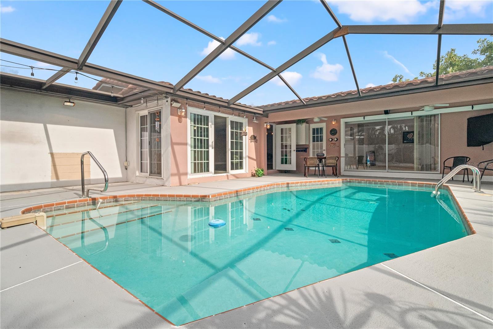The pool area overlooks the canal for a sunset, waterfront view