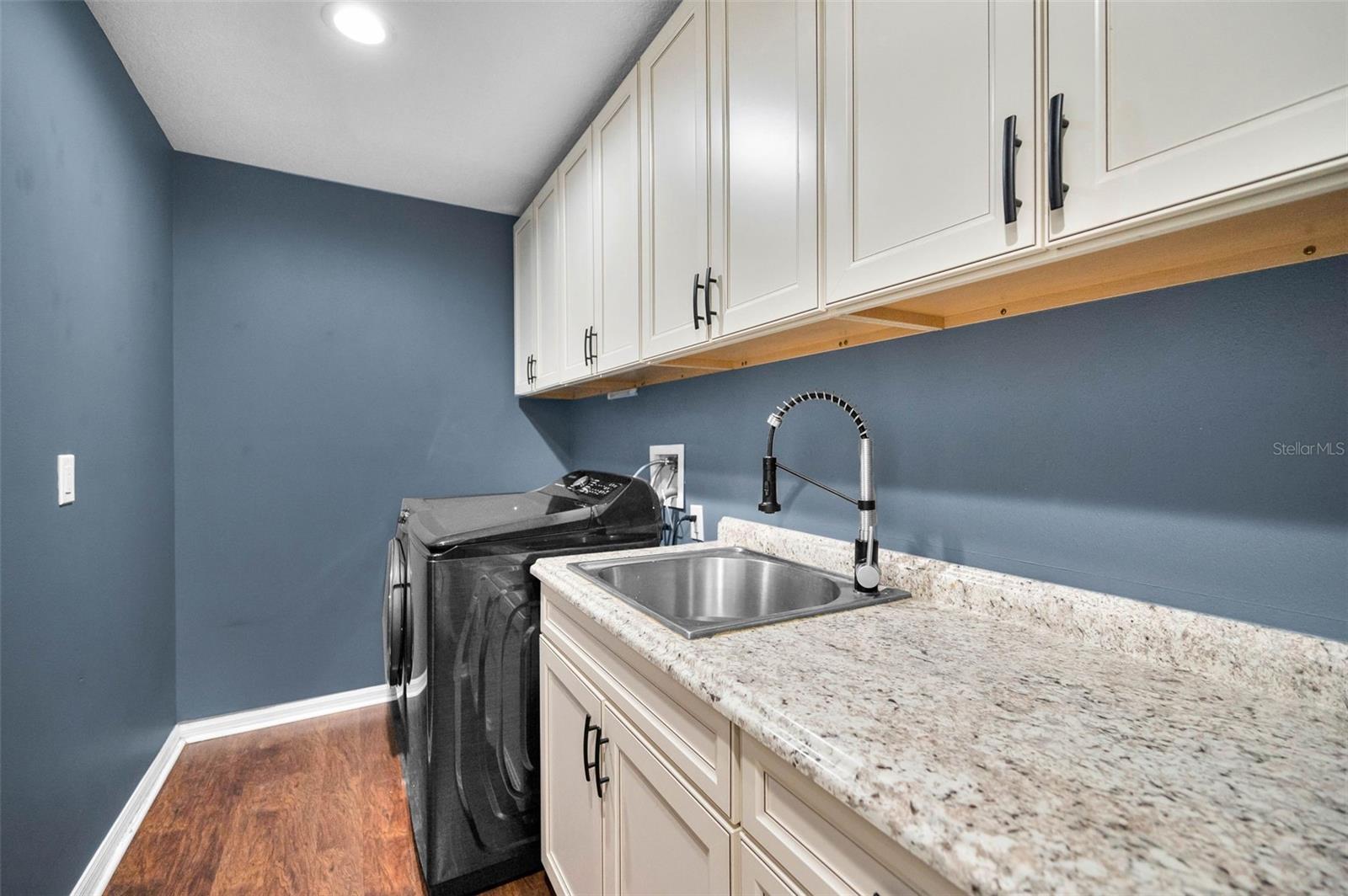 Laundry room with sink and plenty of storage
