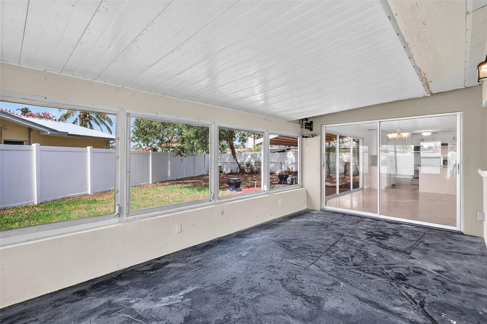 Outaide enclosed porch area off dining room and main bedroom
