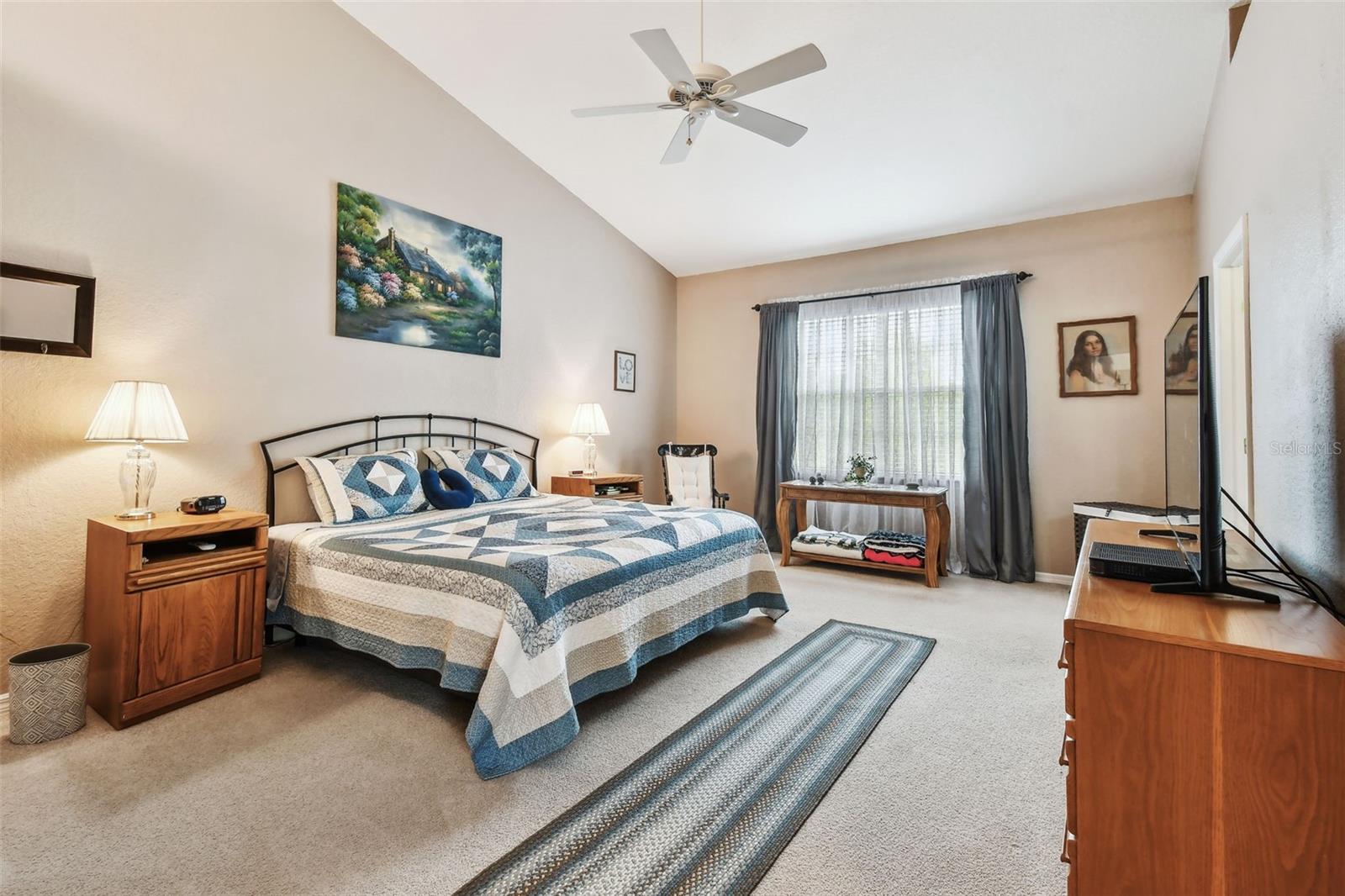 Primary Bedroom with vaulted ceilings and lots of light.