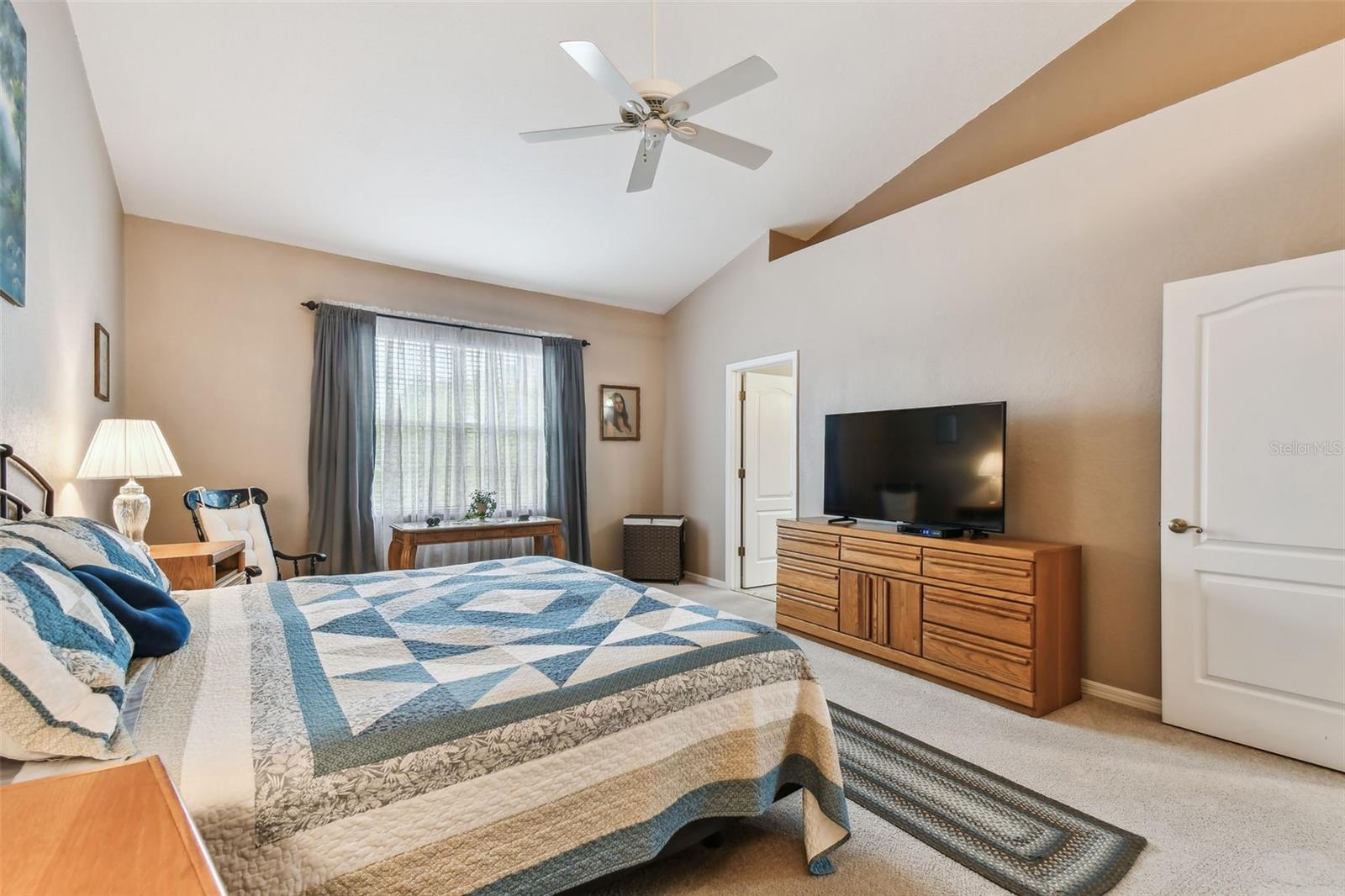 Primary bedroom with ceiling fan.