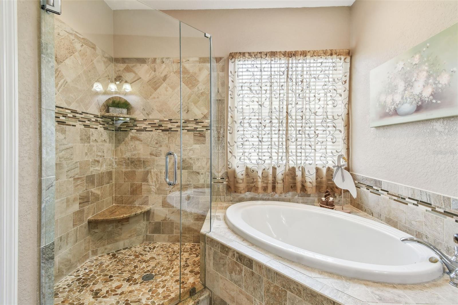 Beautiful glass enclosed shower.