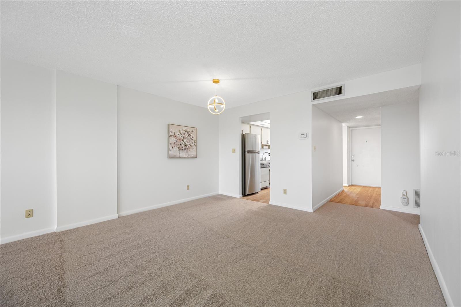 Entry from dining area to kitchen and foyer.