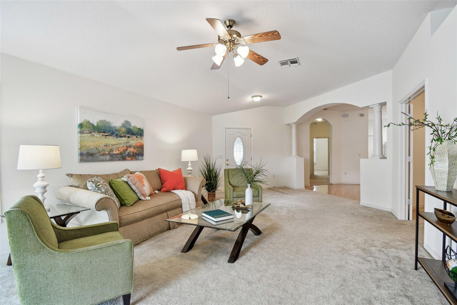 Main Living looking at front door and archway to