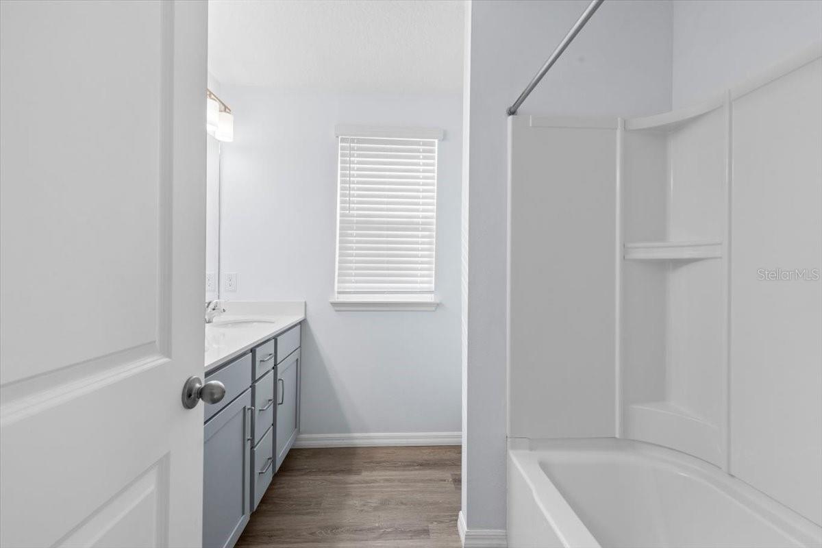 Main Bathroom with tub/shower combo and linen closet.
