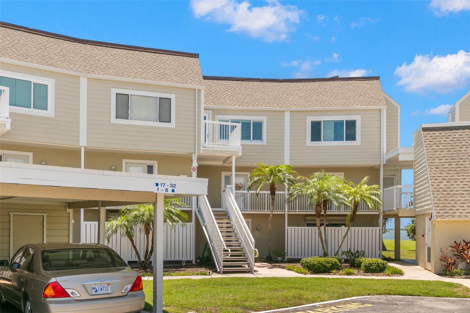 Front view, with entrance  up the stairs. Elvator on right and parking spot 2nd to end