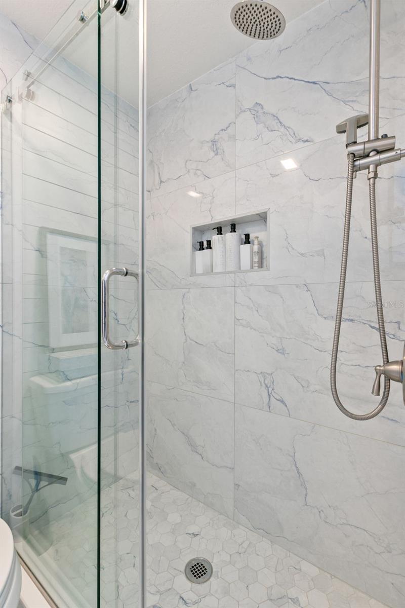 New updated walk in  shower with rain head and niche for essentials.