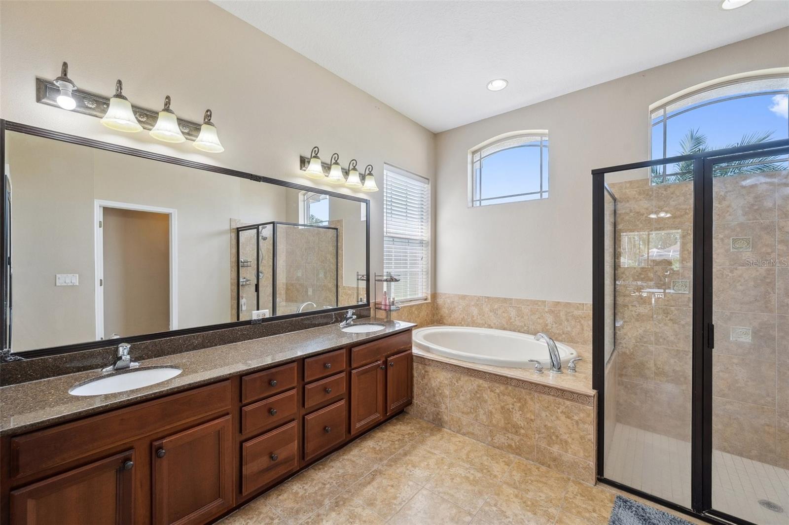 Dual sinks, quartz counters, garden tub, separate shower, private toilet room