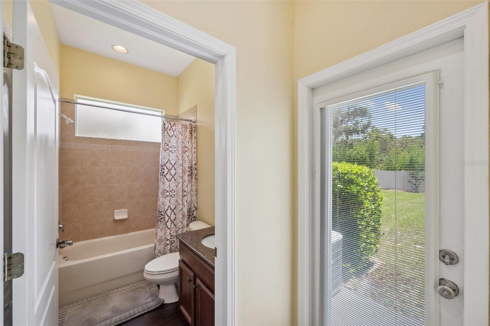 Potential pool bath leads directly to the back yard.