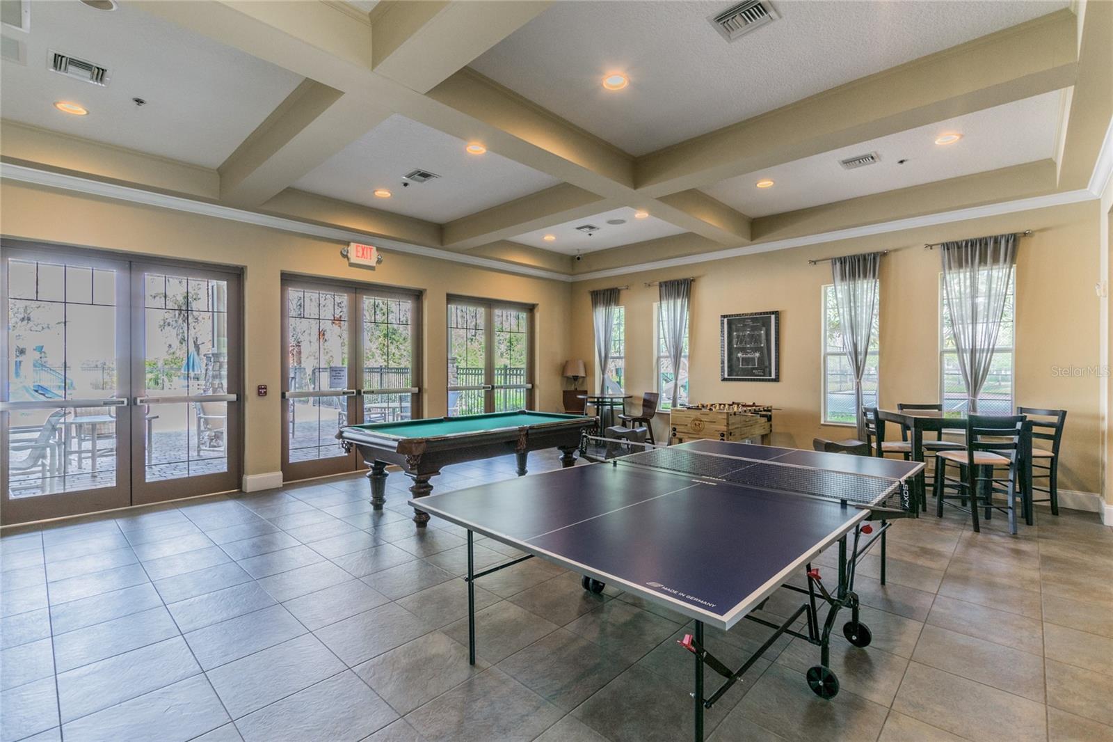 Game room has views of the pool.