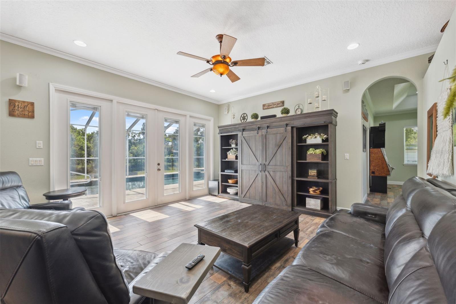 Spacious living room also overlooking the pool area.
