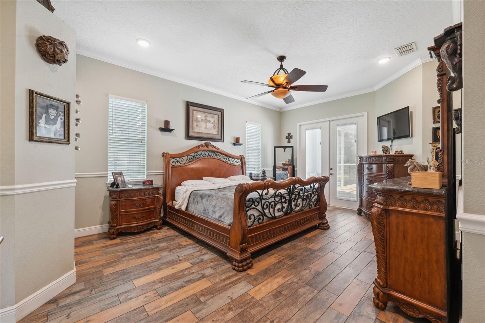 Primary bedroom with double door entry and double doors leading to pool and spa area.