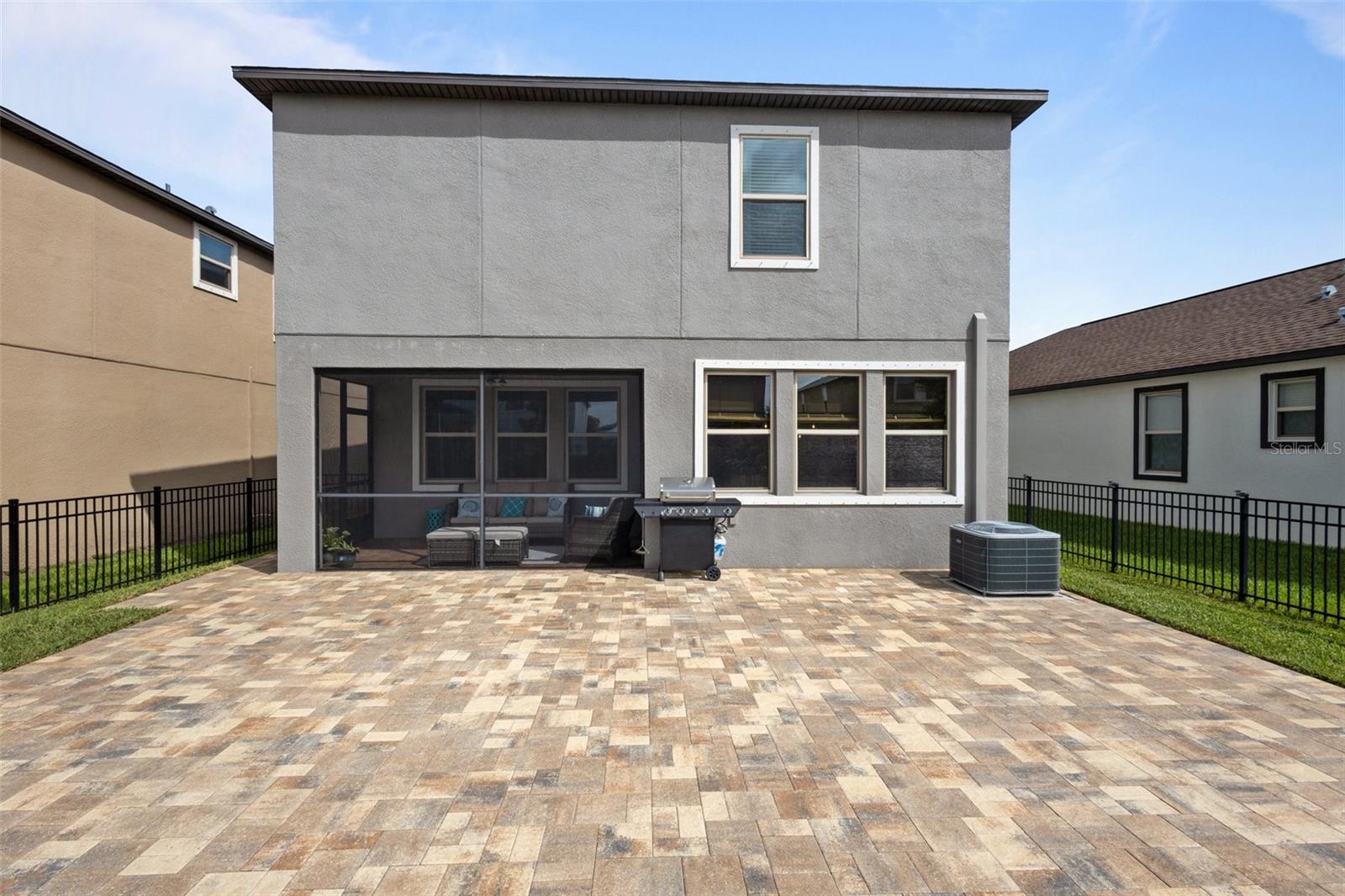 View of rear of home and the expansive extended pavers