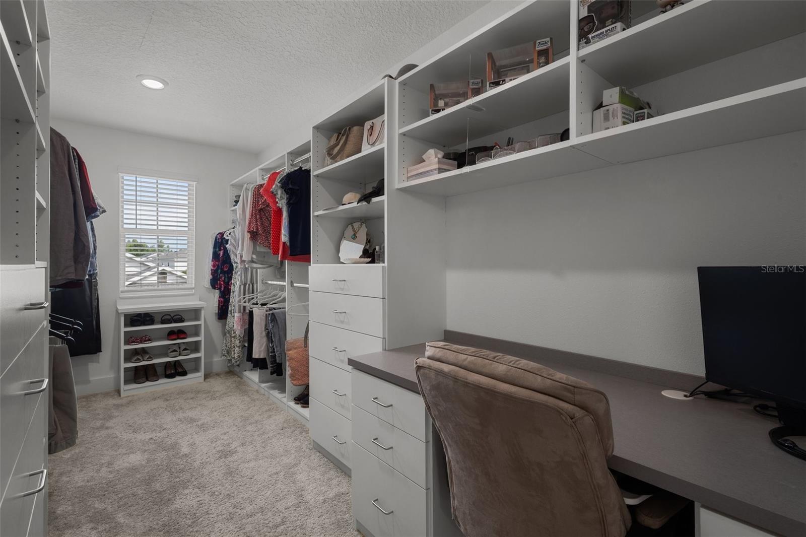 Primary Bedroom Walk in Closet - custom closet with work space