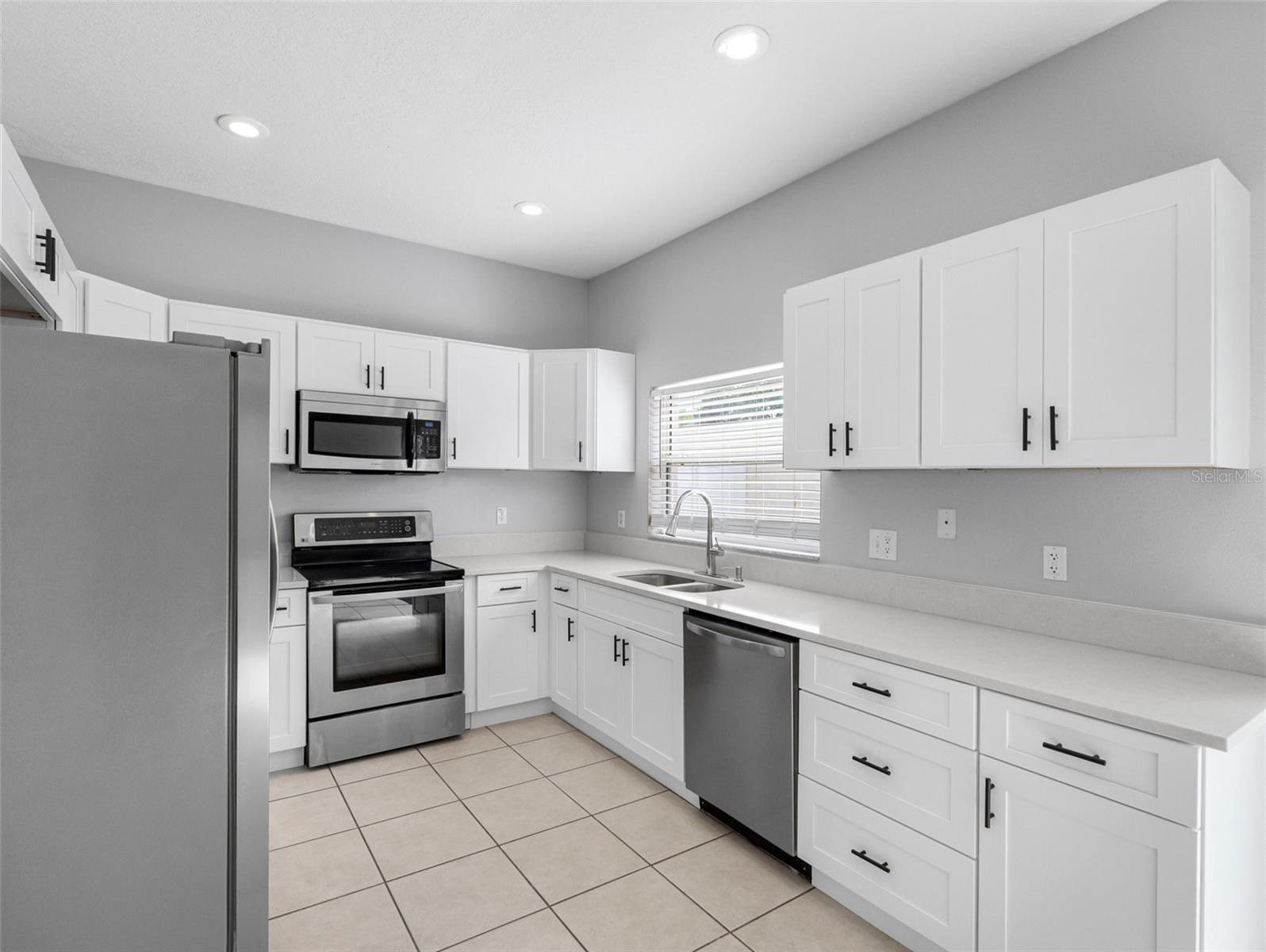 Kitchen with shaker cabinets and stainless appliances