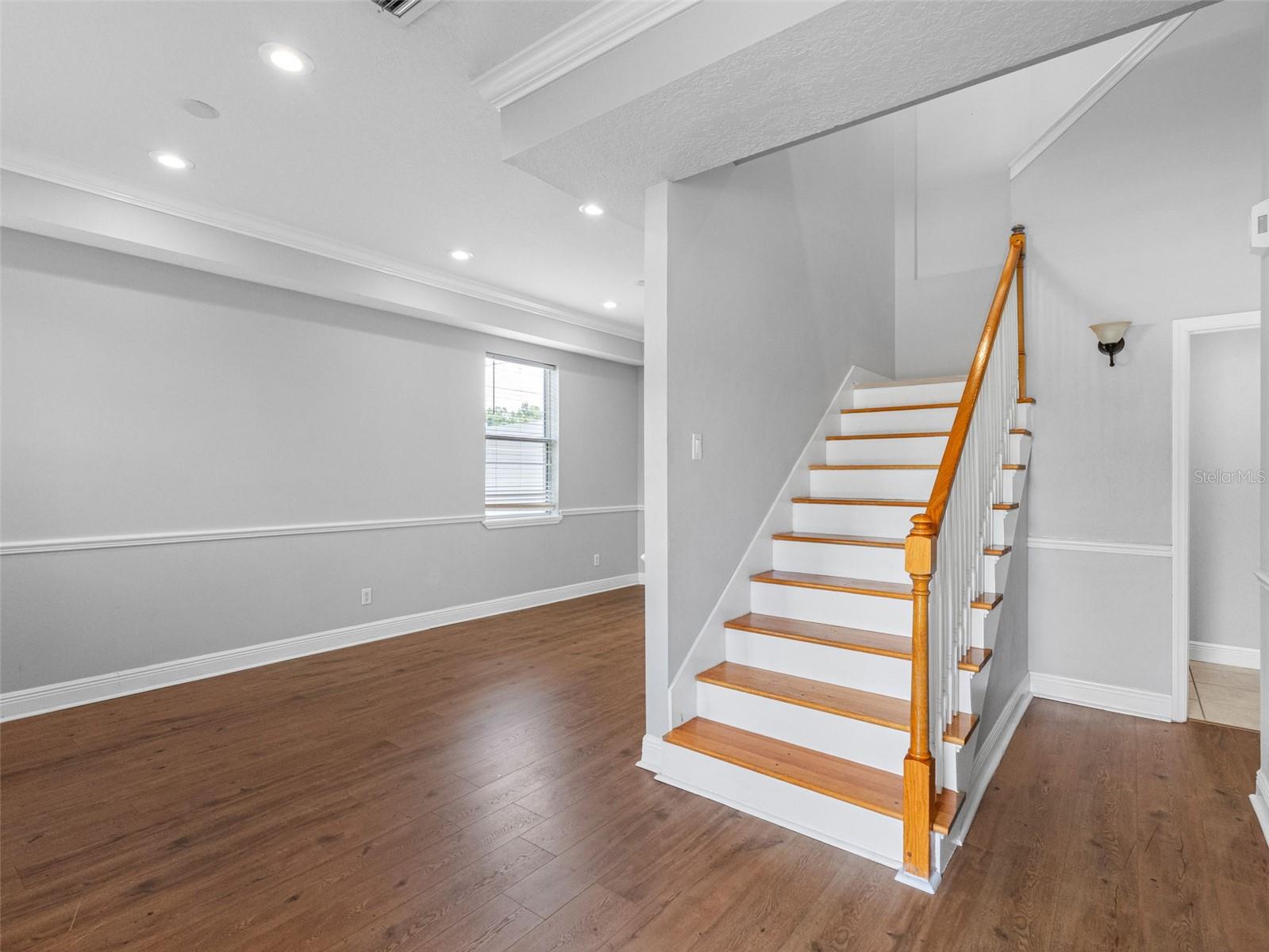 Entrance of home and staircase leading upstairs