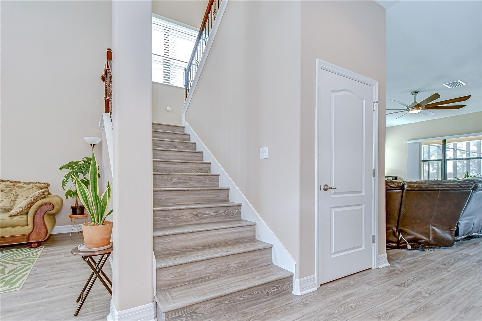 Large under stairs wrap around storage closet and View of formal living room (left) and family room (right).