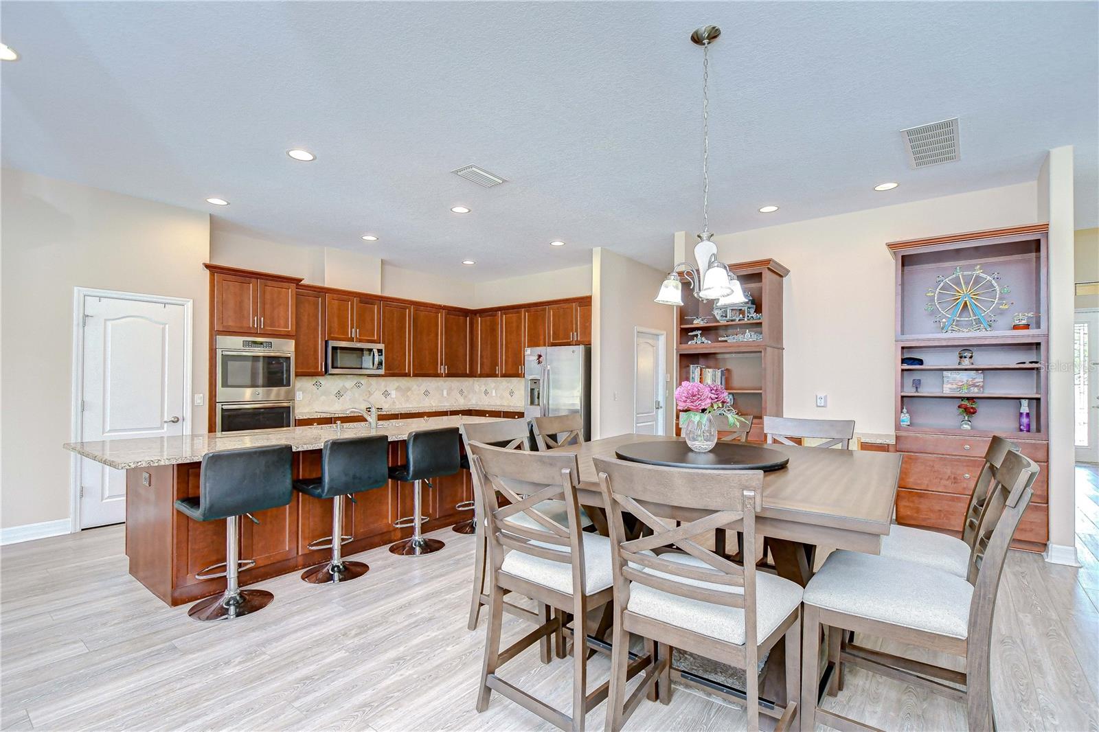 Large island and great breakfast bar in kitchen and custom built in desk with shelves