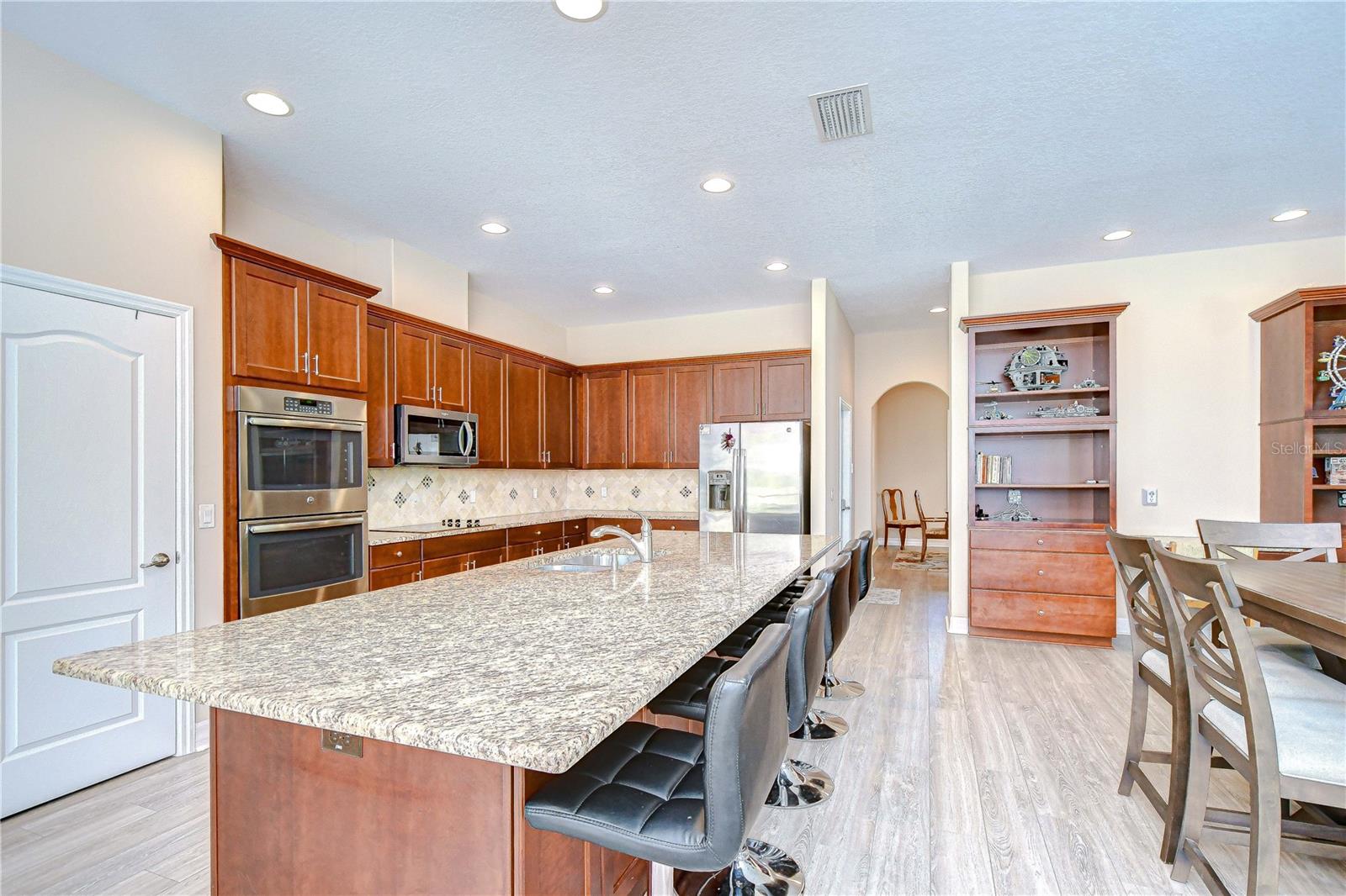Extra large kitchen island and walk through to dining room.