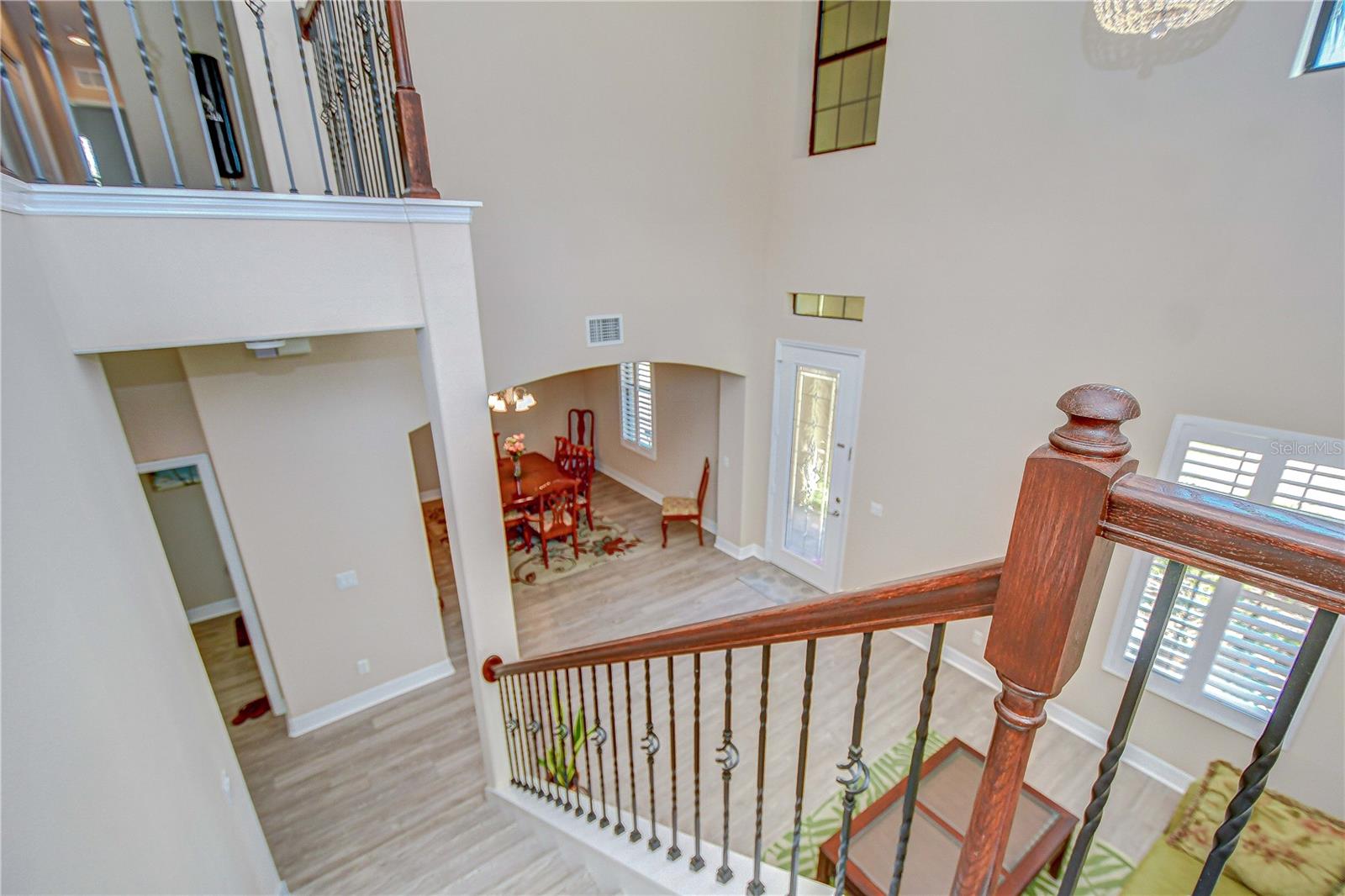 Top of stair landing looking into foyer, living and dining room