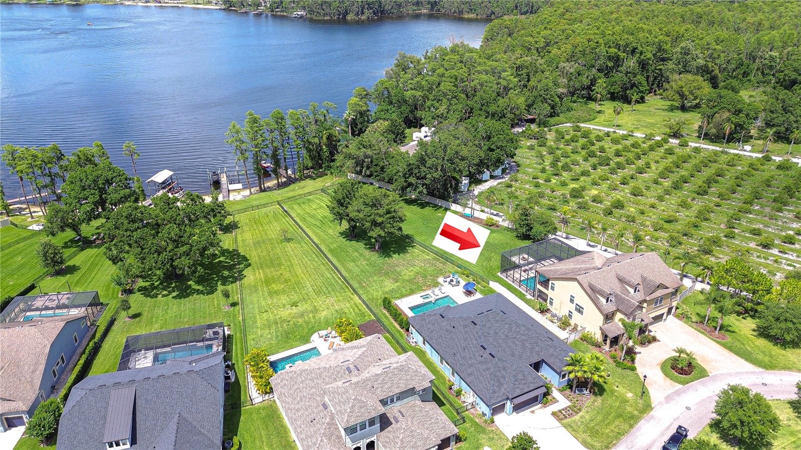 Aerial view of home on lake showing circular driveway too!