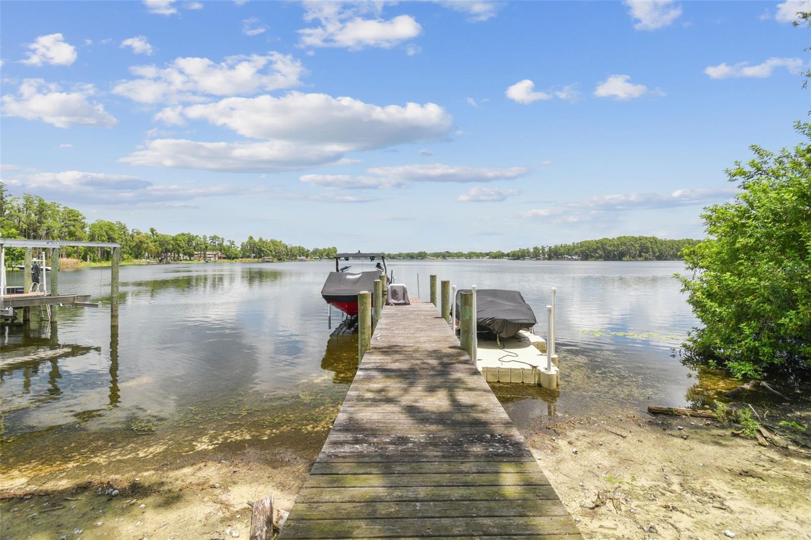Shared dock with neighbor. Has floating boat dock with a Yamaha boat as well.
