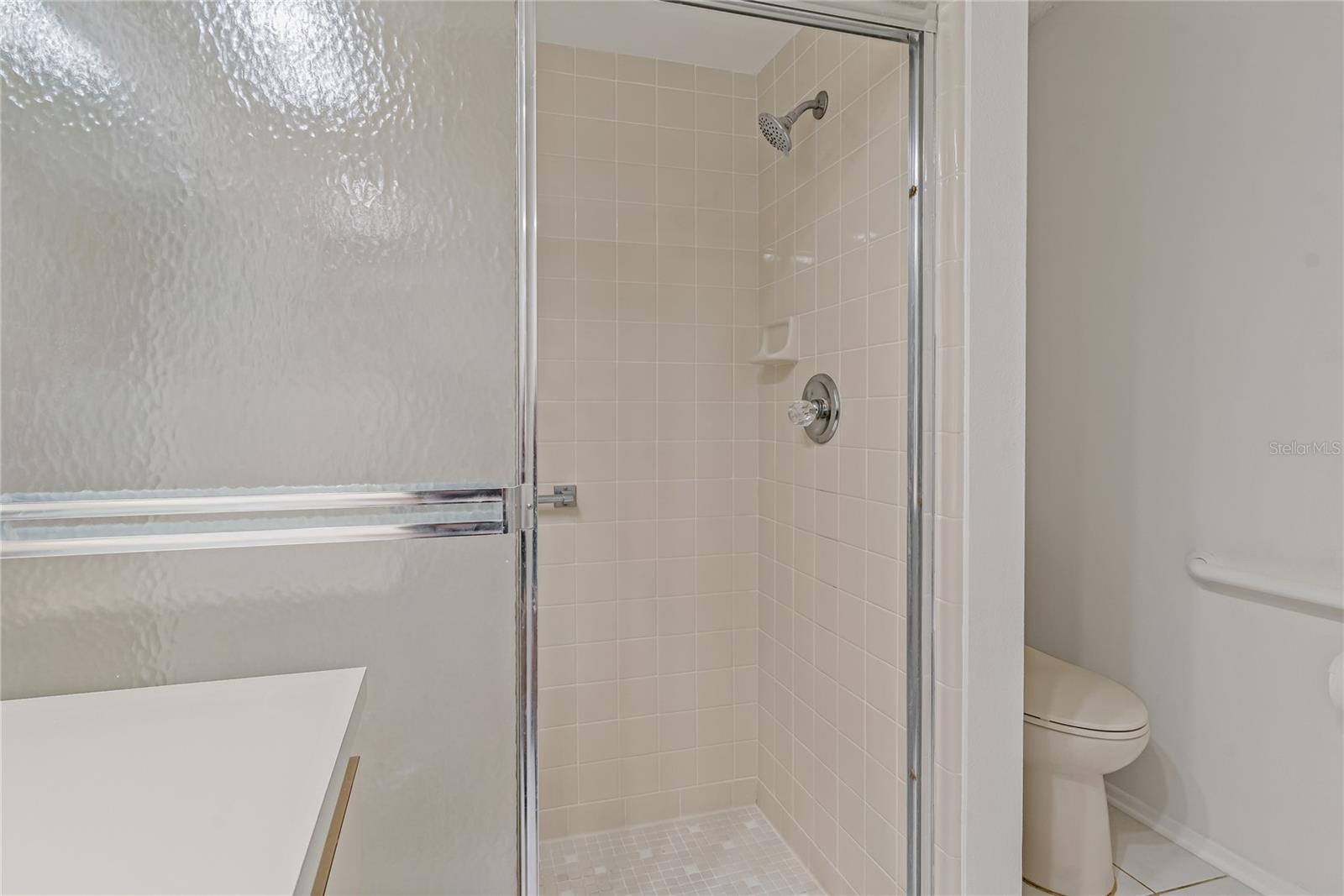WALK IN SHOWER IN THE PRIMARY BATHROOM