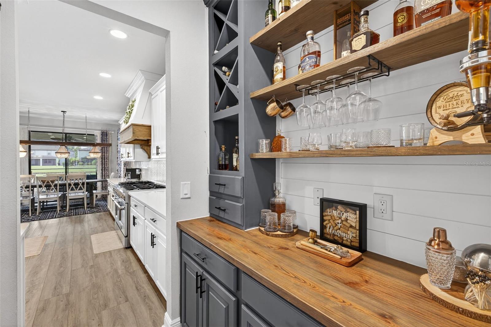 Follow through the workspace to a built in bar/ customized walk-in pantry.