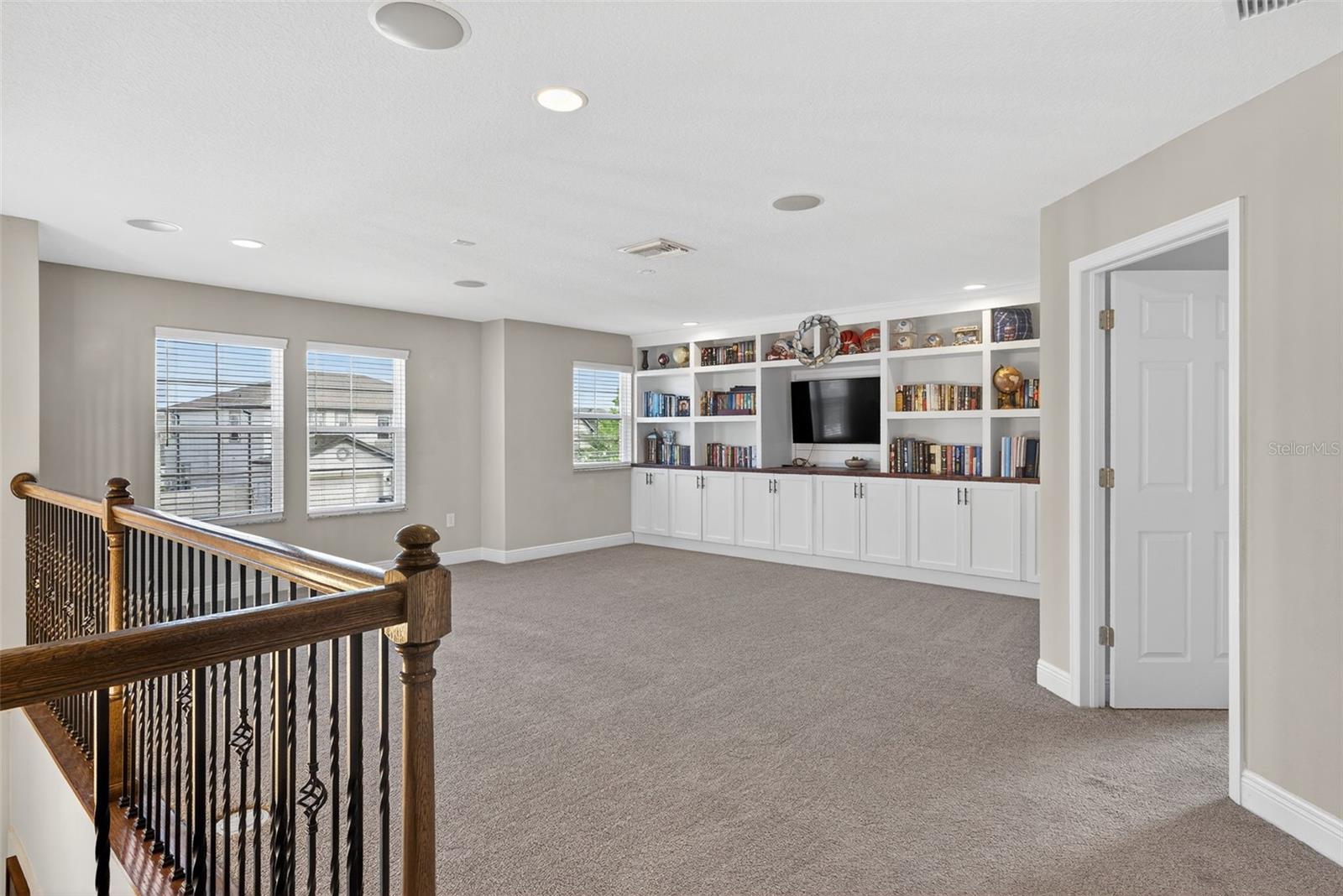 Second floor loft with built-in entertainment center
