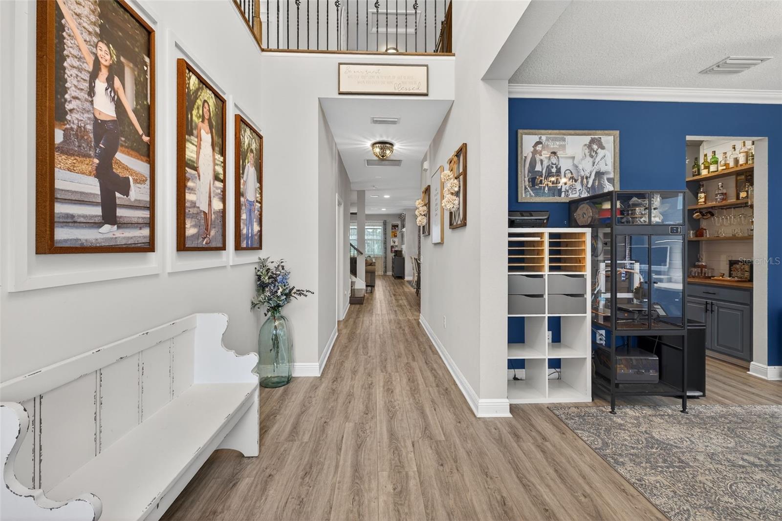 Enter into your 2-story entryway with moulding and upgraded flooring throughout.