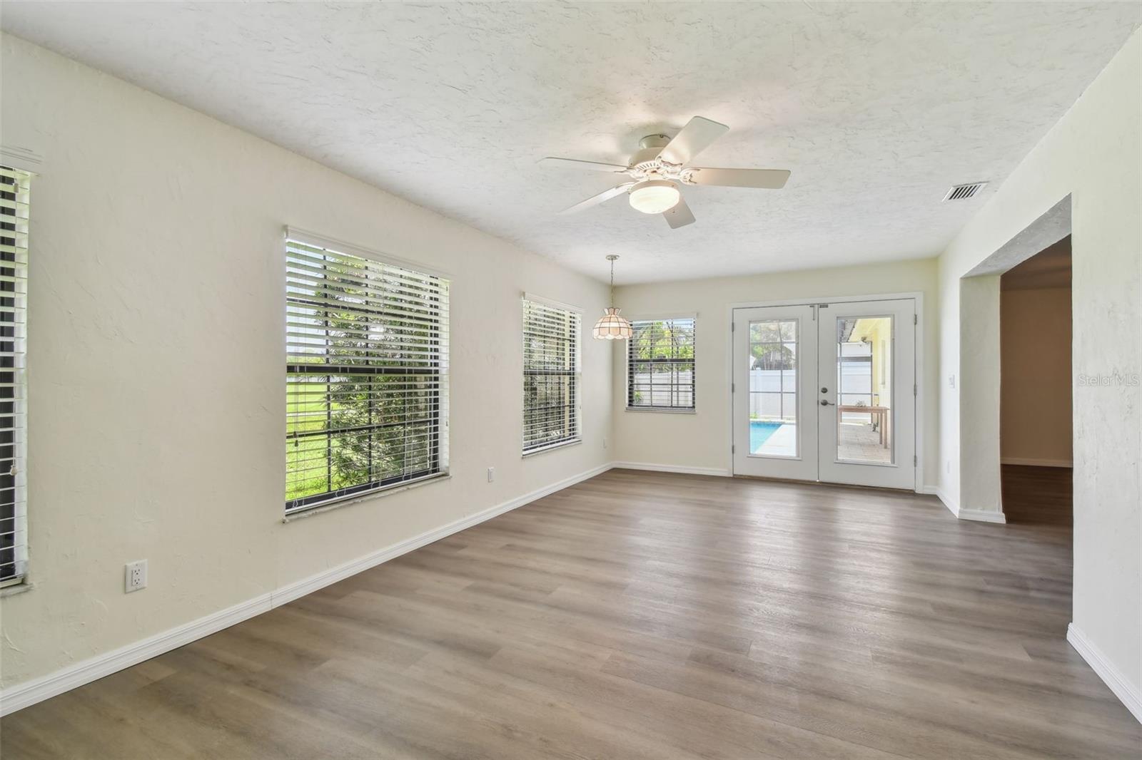 Family Room with Fireplace and French doors to pool