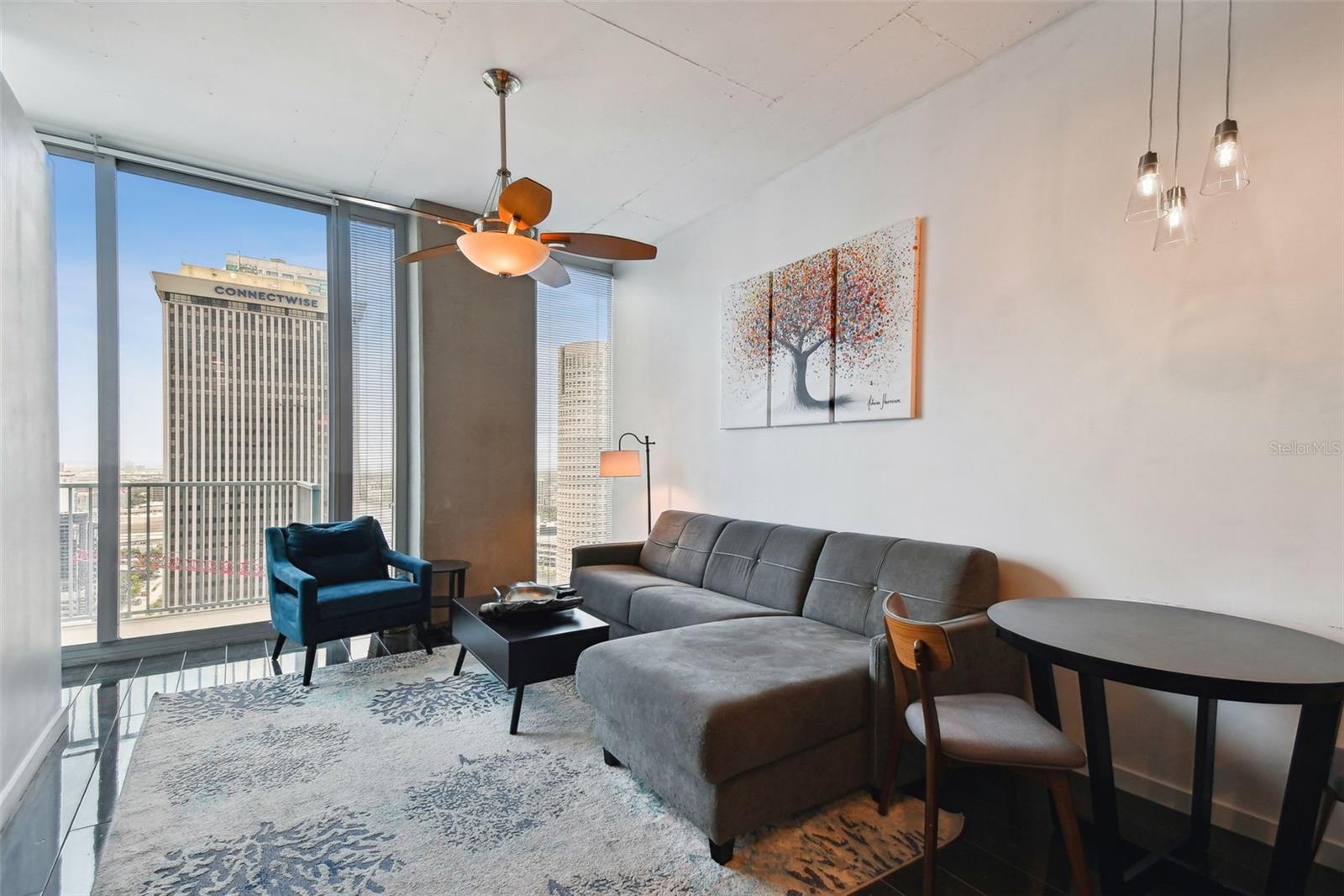 Relax or entertain in this chic living area framed by dramatic windows and stunning downtown vistas.