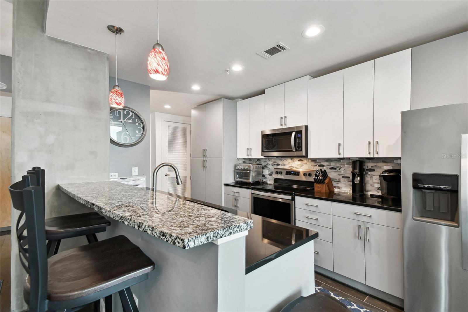 With a bar-height counter and pendant lighting, it's ideal for both casual meals and entertaining guests.
