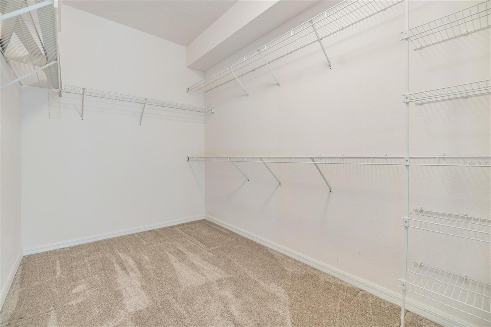 Large walk-in closet with ventilated shelving