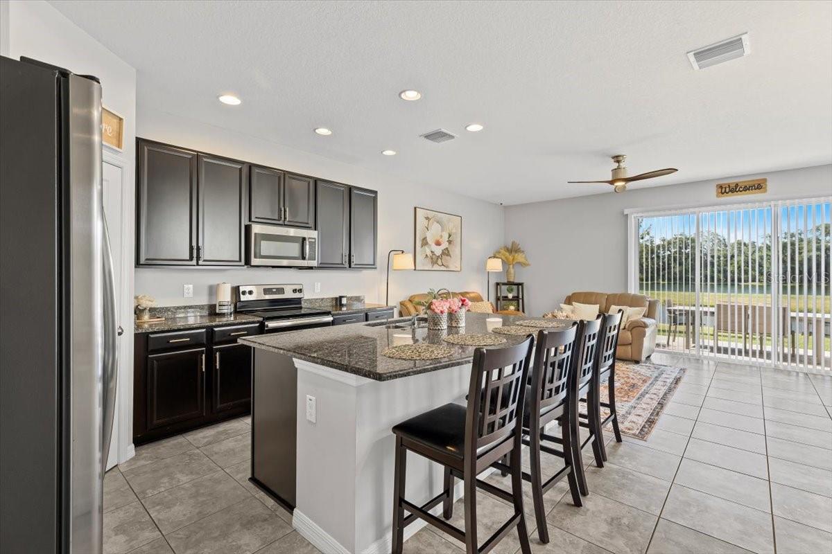 Sleek cabinetry, stainless steel appliances, and ample storage in a thoughtfully designed kitchen.