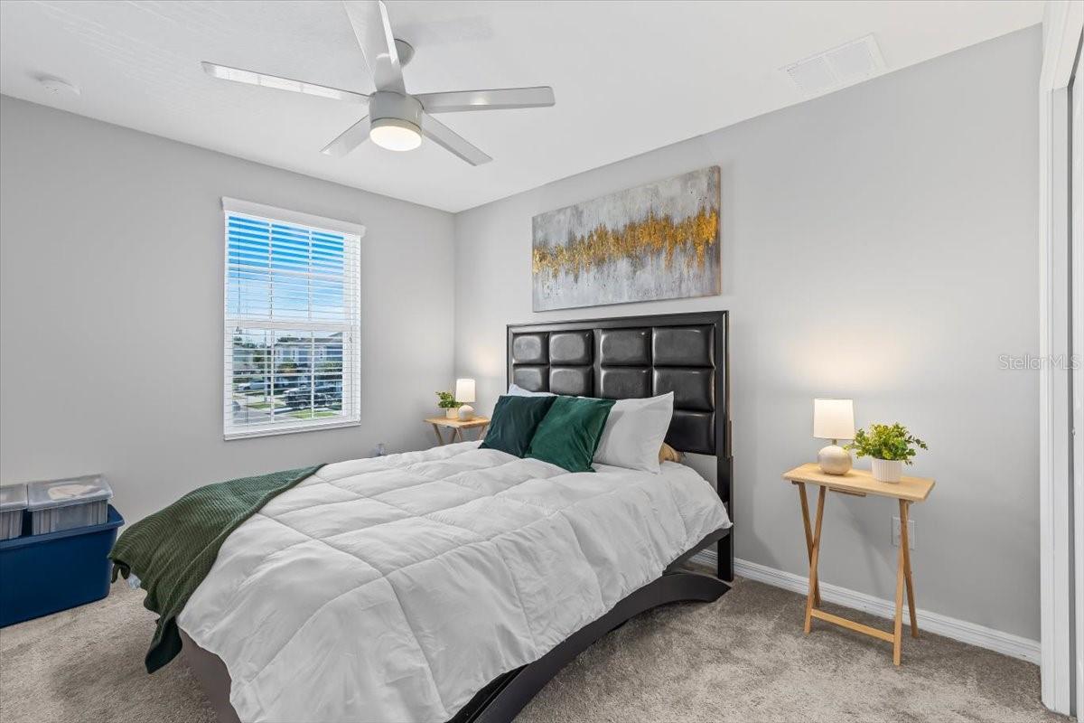Spacious guest room or home office with natural light and large closet.